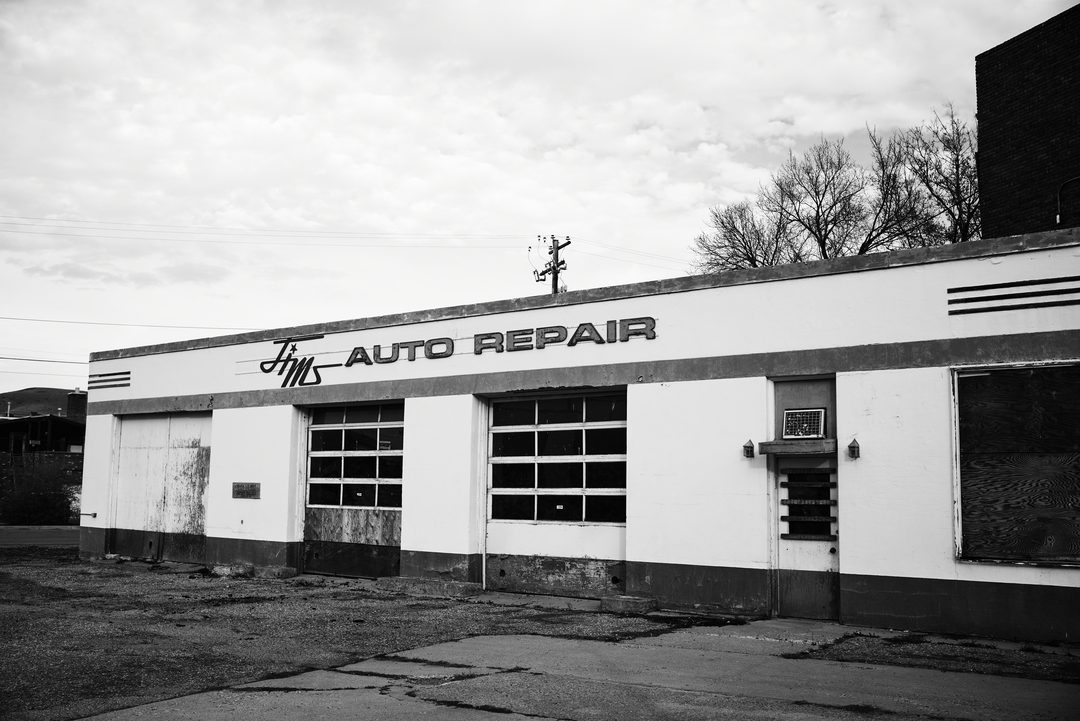 Vintage auto repair shop — black and white documentary photography