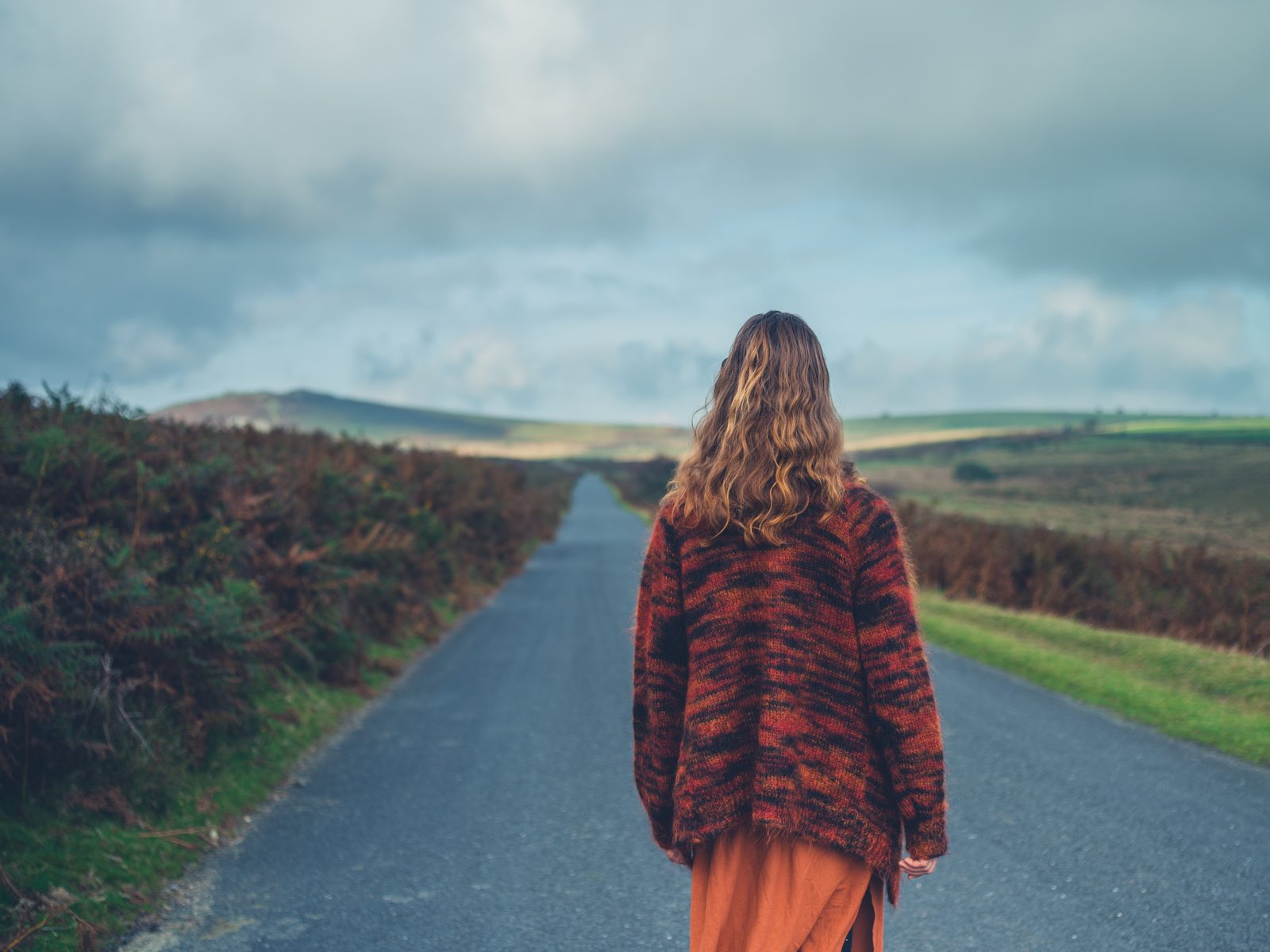 Woman standing in the road on the moor — cinematic portrait photography